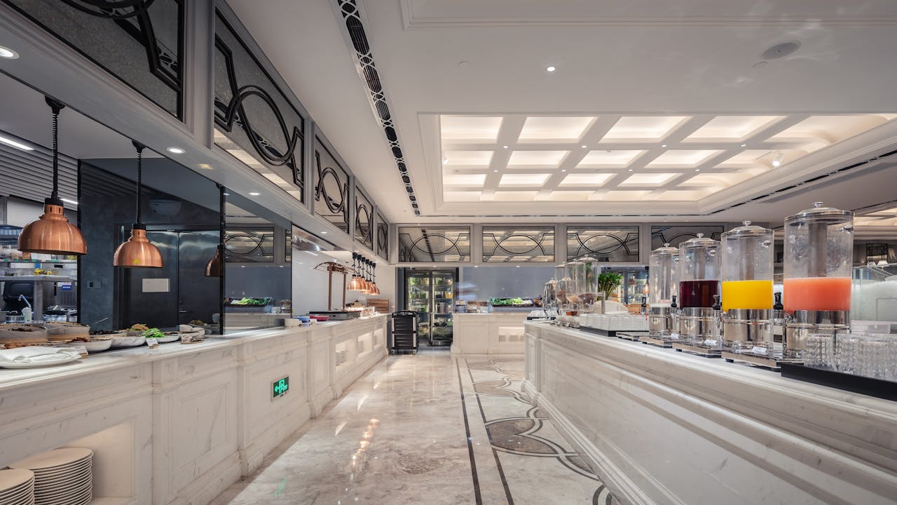 Luxurious hotel buffet area featuring elegant interior design and a variety of juices.